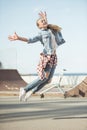 Stylish teenage girl jumping at skateboard park Royalty Free Stock Photo