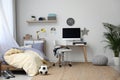 Stylish teenager`s room interior with bed and workplace