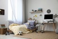 Stylish teenager`s room interior with bed and workplace