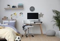 Stylish teenager`s room interior with bed and workplace