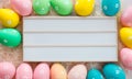 Stylish text frame of the lightbox with eggs everywhere. Colorful Easter eggs top view. . High quality photo Royalty Free Stock Photo