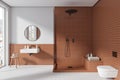 Stylish tile hotel bathroom interior with douche and sink, accessories