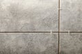 Stylish tiles with spacers on wall in room Royalty Free Stock Photo