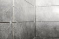 Stylish tiles with spacers on wall in room Royalty Free Stock Photo