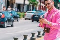 Stylish tourist calling a lift on his smartphone