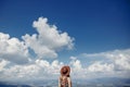 Stylish traveler woman in hat looking at sky and mountains. hips Royalty Free Stock Photo