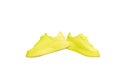 Stylish, trendy, colorful yellow gumshoes, sneakers isolated over white studio background