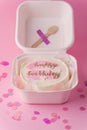 Stylish trendy Korean dessert bento cake with happy birthday inscription in the white gift box on the pink background. Small