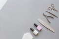 Stylish trendy manicure accessories with gel nail polishes, scissors, cuticle pusher, cotton pad. Flat lay, top view, mock up,