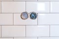 Stylish trendy white ceramic tile with a chamfer on the kitchen wall with electrict section