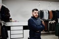 Stylish turkish man at the store of fur coats and leather jackets. Successful arabian beard man