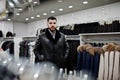 Stylish turkish man at the store of fur coats and leather jackets. Successful arabian beard man