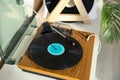 Stylish turntable with vinyl disc and headphones on white table at home, closeup Royalty Free Stock Photo