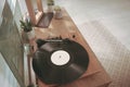 Stylish turntable with vinyl record on wooden table indoors, above view Royalty Free Stock Photo