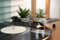 Stylish turntable with vinyl record on wooden table indoors, closeup Royalty Free Stock Photo