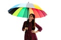 stylish tween girl. happy child hold colorful parasol. kid with rainbow umbrella isolated on white. Royalty Free Stock Photo