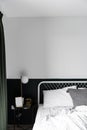 Stylish two tone green and white  bedroom corner with decorative frame and plant in scandinavian style apartment Royalty Free Stock Photo