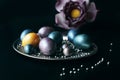 Stylish unusual eggs painted for Easter lie on a silver tray