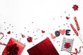 Stylish Valentine`s day romantic decoration. Gifts, heart shape, confetti, sweets, black and red decorations on white background.