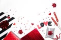 Stylish Valentine`s day romantic decoration. Gifts, heart shape, confetti, sweets, black and red decorations on white background.
