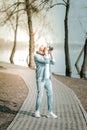 Stylish vigorous septuagenarian woman taking pictures in the park