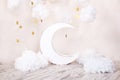 Stylish vintage children`s room with a wooden moon and textile clouds. Children location for a photo shoot. Moon with stars and cl