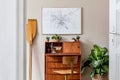 Stylish and vintage home office interior with wooden retro commode.