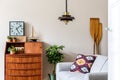 Stylish, vintage living room interior with wooden retro commode.