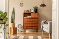 Stylish and vintage interior design of open space with retro furniture, plants and decoration. Royalty Free Stock Photo