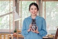 Stylish vintage female photographer holding her old  twin lens camera to her chest as she composes her image Royalty Free Stock Photo