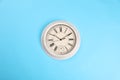 Stylish vintage wall clock on turquoise background, top view Royalty Free Stock Photo