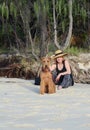 Stylish vogue mature senior woman on summer beach holiday with pet dog Royalty Free Stock Photo