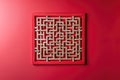 A stylish wall hanging featuring geometric maze patterns, isolated on a solid ruby red background Royalty Free Stock Photo