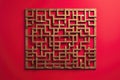 A stylish wall hanging featuring geometric maze patterns, isolated on a solid ruby red background Royalty Free Stock Photo