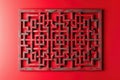 A stylish wall hanging featuring geometric maze patterns, isolated on a solid ruby red background Royalty Free Stock Photo
