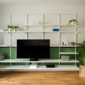 Stylish wall shelves and big television Royalty Free Stock Photo