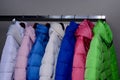 Stylish warm coats on rail in shop Royalty Free Stock Photo