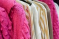 Stylish warm colorful clothes on hangers in the store Royalty Free Stock Photo