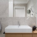 Stylish washbasin in bathroom with modern, patterned tiles, close-up