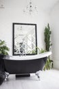 Stylish washroom with big black and white bathtub Royalty Free Stock Photo