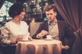 Stylish wealthy couple drinking coffee Royalty Free Stock Photo