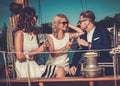 Stylish wealthy friends having fun on a luxury yacht Royalty Free Stock Photo