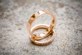 Stylish wedding pink gold rings on stone background