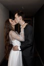 Newlyweds with a dark hotel, a wedding photo shoot. Stylish wedding, shooting with flashes.