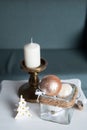 Stylish white large candl on the table, and New Year`s balls, photos in gentle pastel colors. Christmas mood Royalty Free Stock Photo