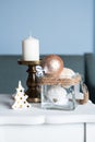 Stylish white large candl on the table, and New Year`s balls, photos in gentle pastel colors. Christmas mood Royalty Free Stock Photo