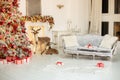 Stylish white living room interior with decorated Christmas tree, fireplace and sofa with pillows. Christmas at home Royalty Free Stock Photo