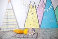 Stylish white modern kids room. Kids wigwam in childrens room. Scandinavian style of interior. Spacious bedroom for a child with a Royalty Free Stock Photo