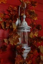 Stylish white street lamp decorated in autumn with red leaves Royalty Free Stock Photo