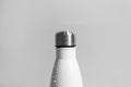 Stylish white thermo bottle with water drops on light grey background, closeup Royalty Free Stock Photo